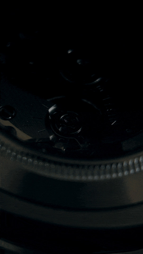 NH34A automatic movement, marked rotor and balance wheel through a clear caseback, animated close-up