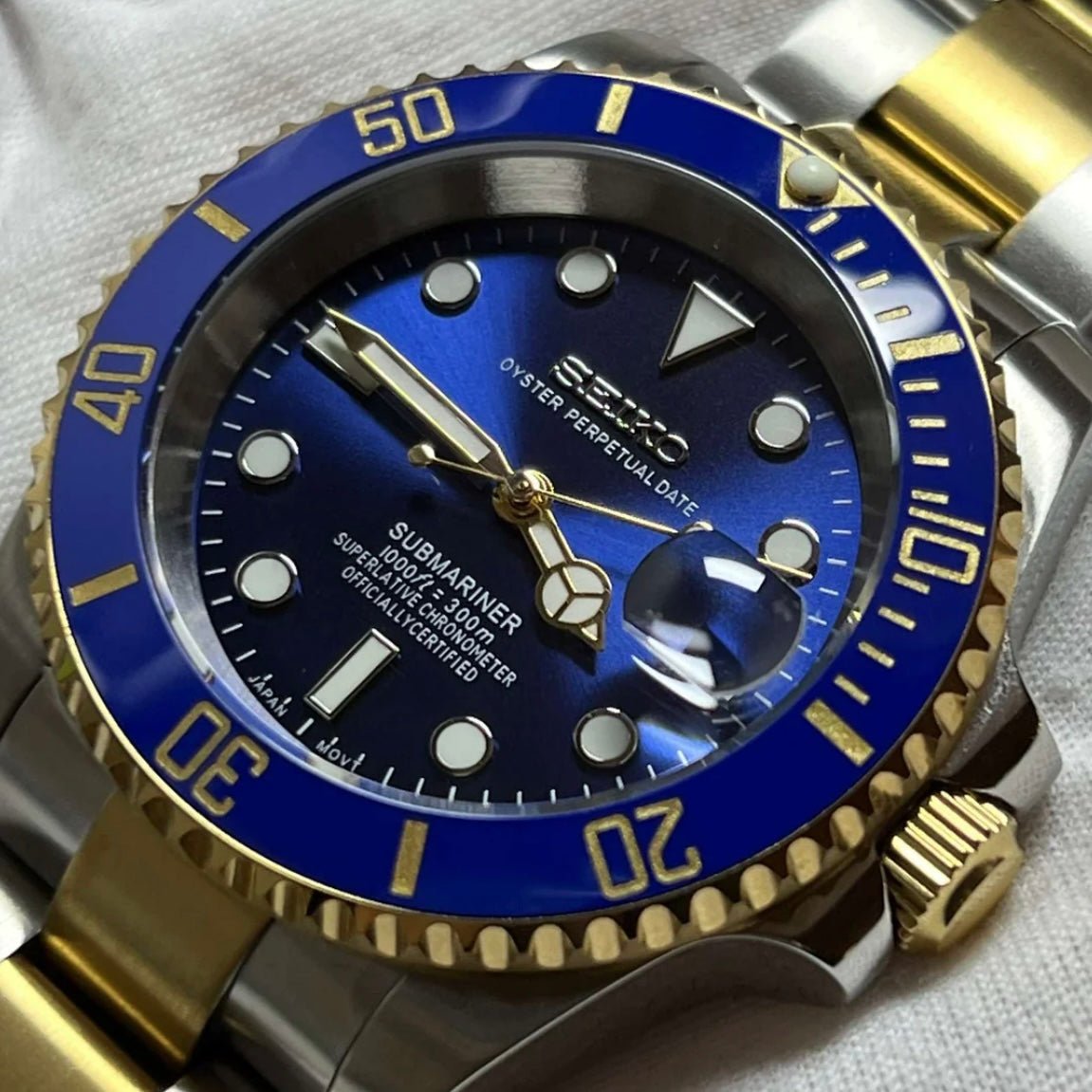 Montre automatique de style Submariner — configuration bicolore, «Ocean» (NH35) avec lunette bleue, marquages aux tons dorés, gros plan en biais