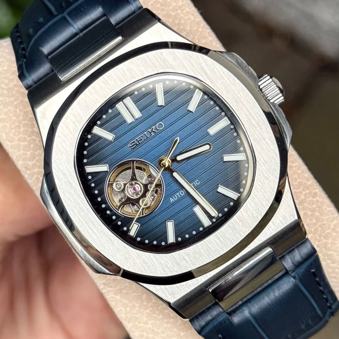 ModTime silver and blue Nautilus Mod Silver Blue Open Heart Dial Leather Strap watch travel accessory for custom watches - angled dial view