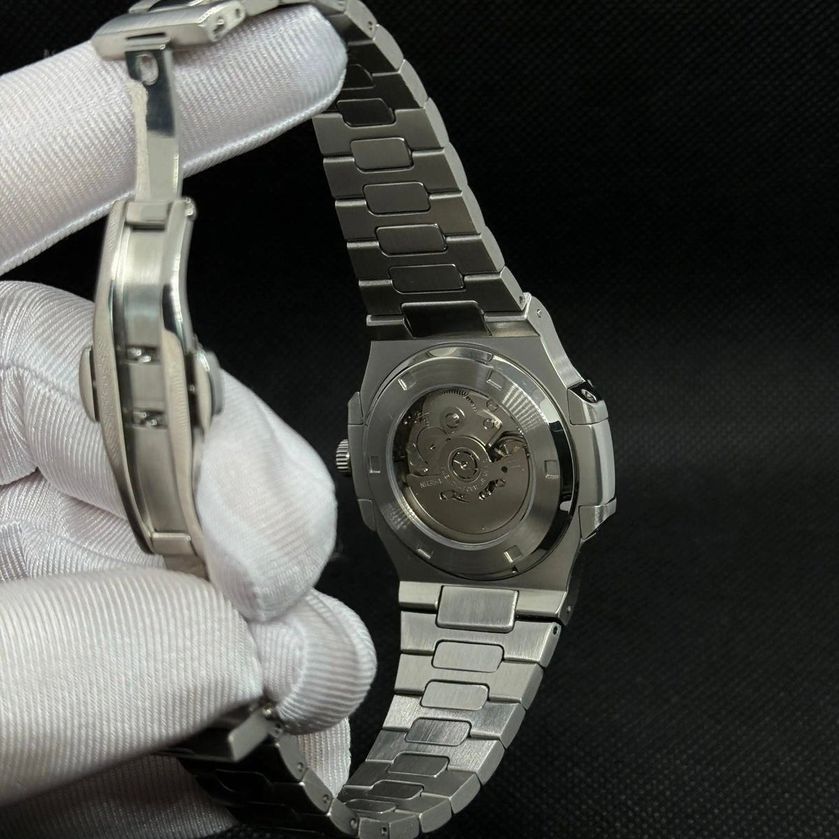 ModTime Nautilus-style Silver Skeleton listing (NH38): silver-tone caseback, rotor marked NH35A, open-bracelet rear view